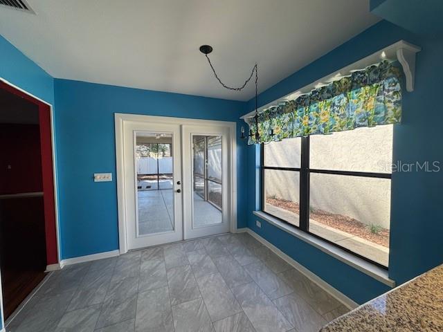 interior space featuring french doors, visible vents, and baseboards