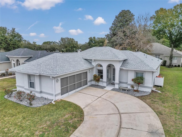 ranch-style home with a front lawn and a garage