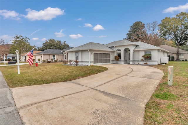 view of front of house with a front lawn and a garage