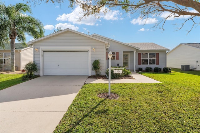 ranch-style home featuring a garage, central air condition unit, and a front lawn