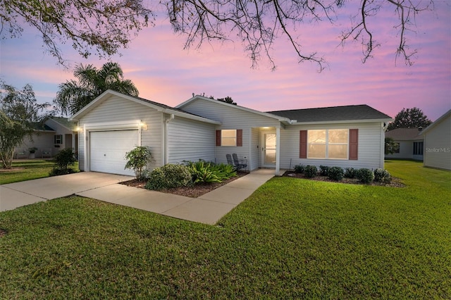 single story home featuring a yard and a garage