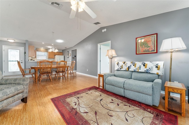 living room with light wood-type flooring, ceiling fan, and lofted ceiling