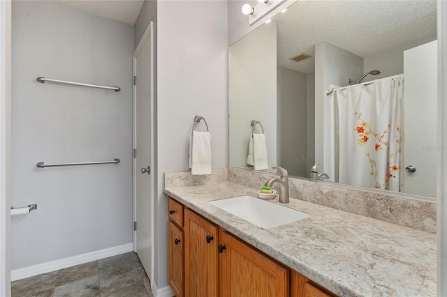 bathroom with vanity and a textured ceiling