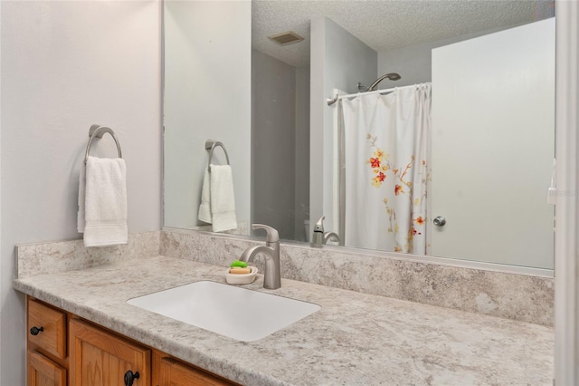 bathroom with vanity and a textured ceiling