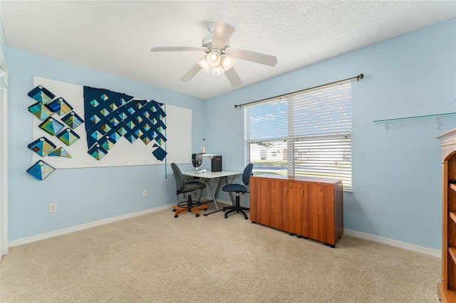 office space with light carpet, a textured ceiling, and ceiling fan