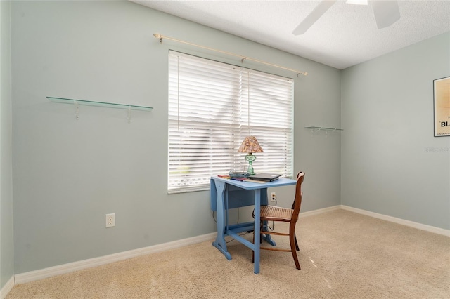 office area with ceiling fan, a healthy amount of sunlight, and light colored carpet