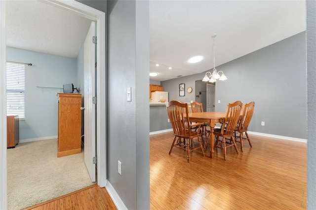 dining area with a chandelier and light hardwood / wood-style floors