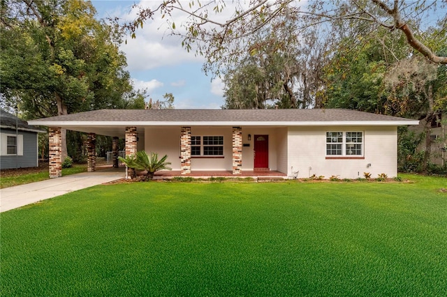 ranch-style home featuring a carport, covered porch, and a front lawn