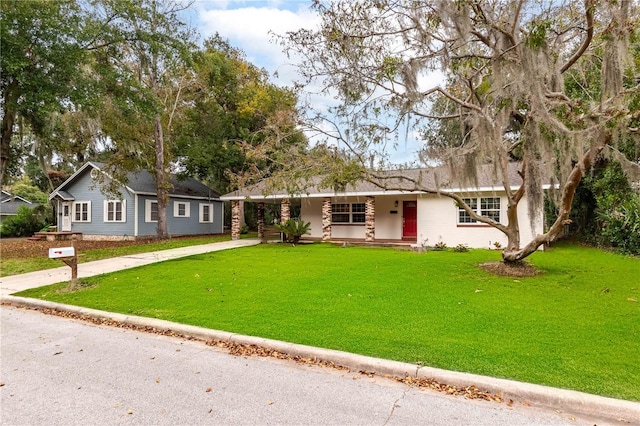 ranch-style house featuring a porch and a front lawn