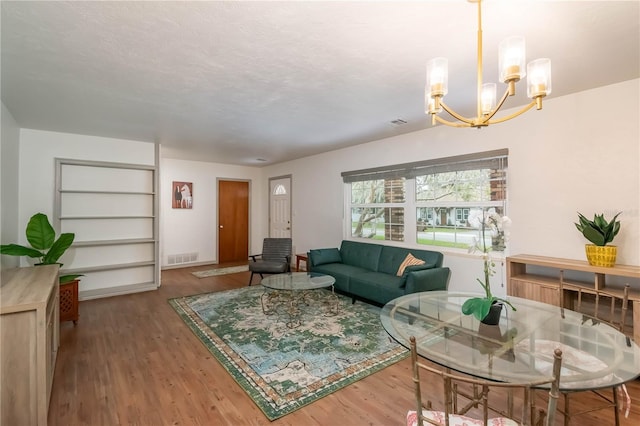 living room featuring hardwood / wood-style flooring and a notable chandelier