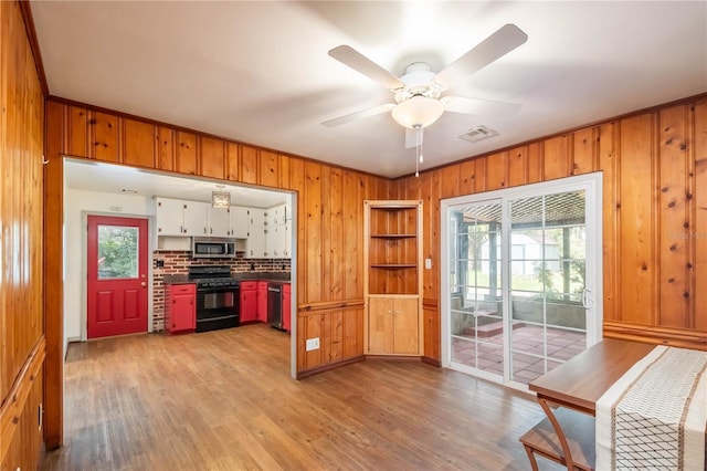 kitchen with white cabinets, ceiling fan, light wood-type flooring, tasteful backsplash, and stainless steel appliances