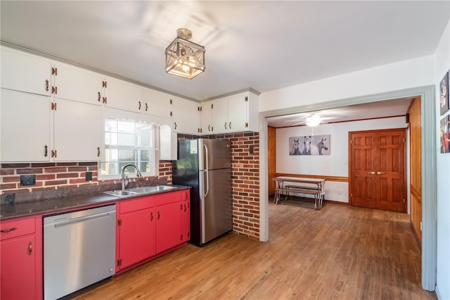 kitchen featuring stainless steel appliances, ceiling fan, sink, light hardwood / wood-style flooring, and white cabinets