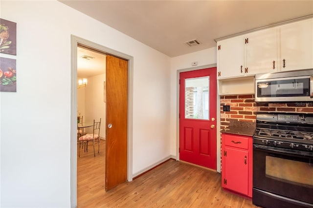 kitchen featuring white cabinets, light hardwood / wood-style floors, and black range with gas cooktop