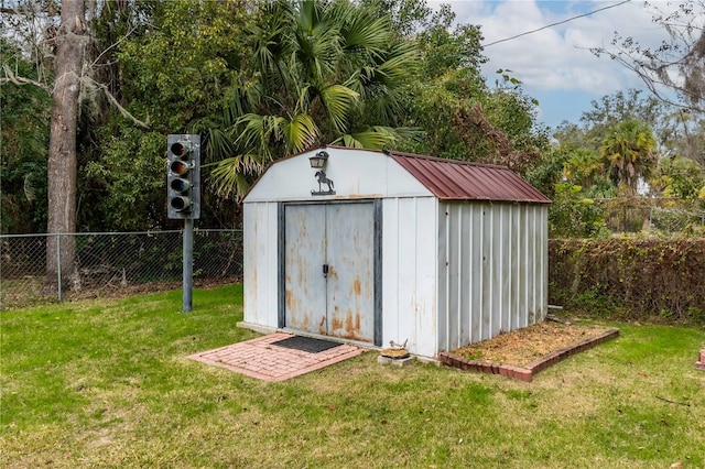 view of outbuilding featuring a lawn