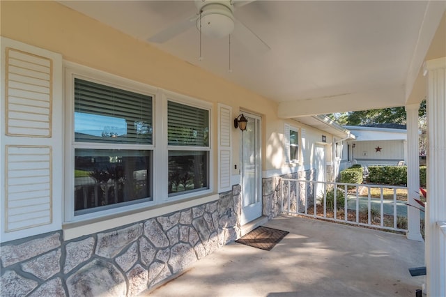 view of patio featuring ceiling fan and a porch