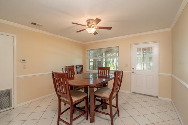 tiled dining room with crown molding and ceiling fan