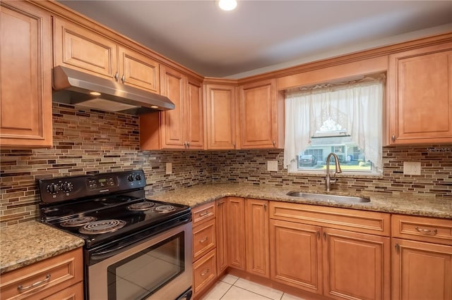 kitchen with decorative backsplash, light stone counters, black range with electric cooktop, sink, and light tile patterned floors