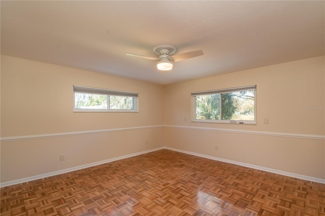 spare room featuring ceiling fan, parquet floors, and a textured ceiling