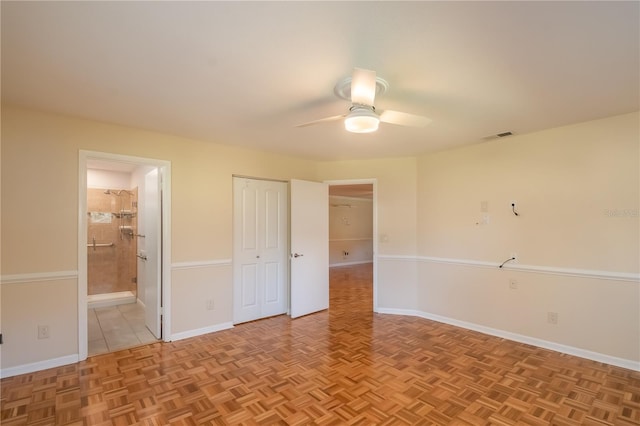 unfurnished bedroom featuring ensuite bathroom, ceiling fan, and light parquet floors