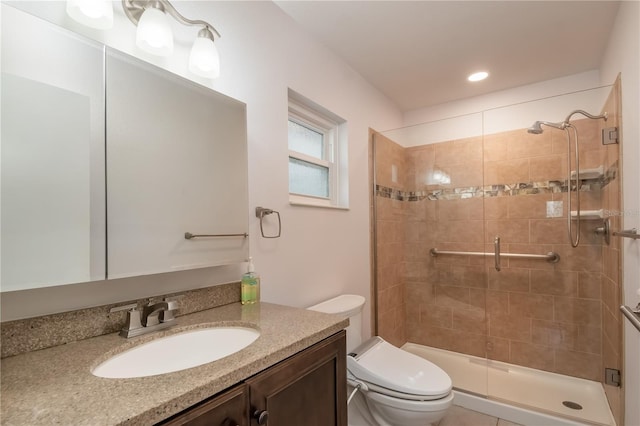 bathroom with vanity, toilet, and a shower with shower door