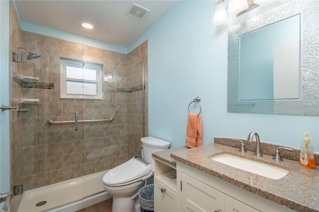 bathroom featuring vanity, toilet, and an enclosed shower