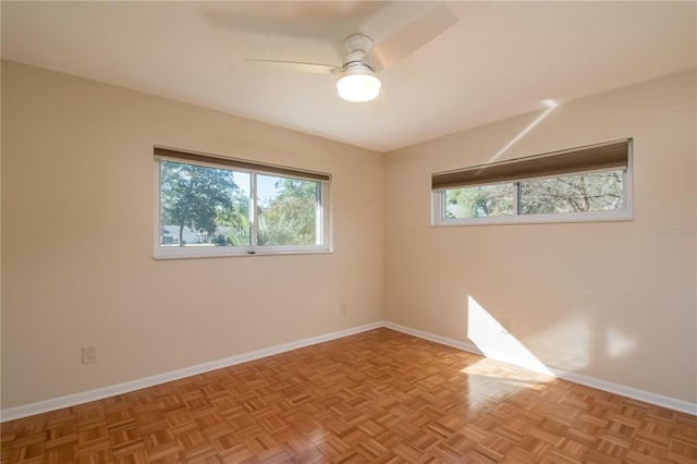 empty room featuring light parquet flooring and ceiling fan