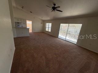 unfurnished living room with ceiling fan and lofted ceiling