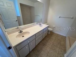 bathroom featuring vanity and toilet