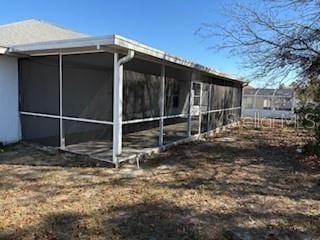 view of property exterior featuring a sunroom