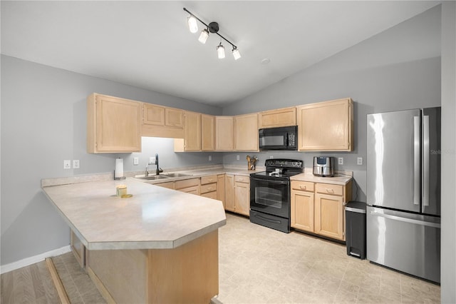 kitchen with light brown cabinetry, kitchen peninsula, sink, and black appliances