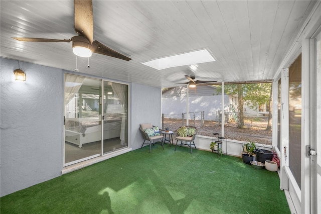 unfurnished sunroom with a skylight and ceiling fan