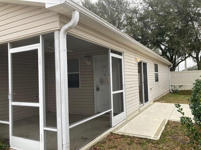 view of side of home featuring a sunroom