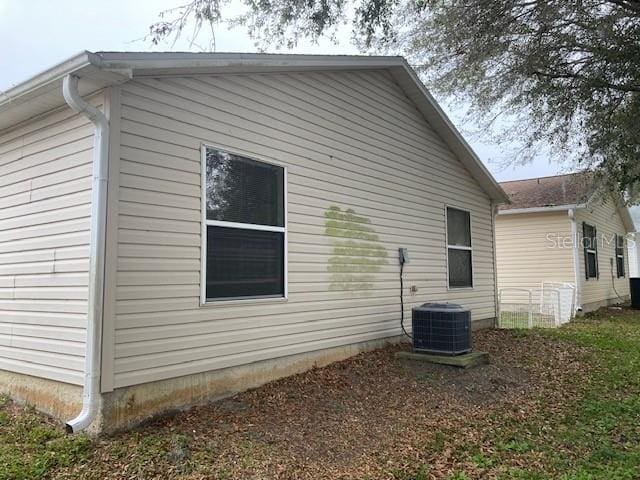 view of side of home featuring central AC unit