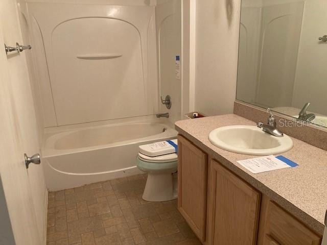 full bathroom with bathing tub / shower combination, vanity, and toilet