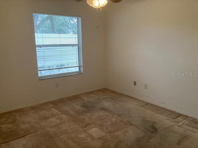 carpeted empty room with ceiling fan