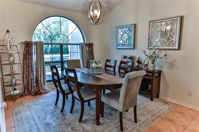 dining room featuring an inviting chandelier, lofted ceiling, and light tile patterned floors