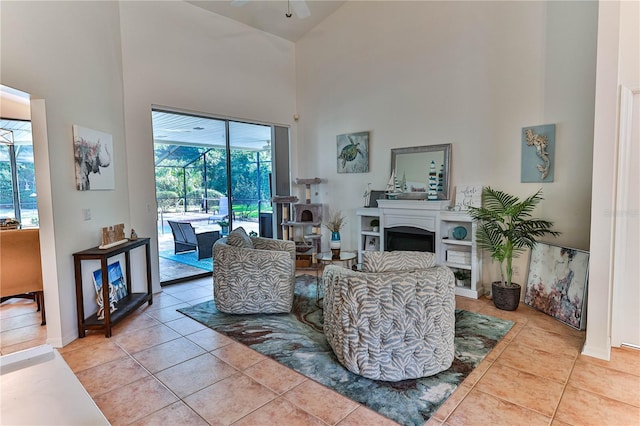 tiled living room featuring a high ceiling and ceiling fan