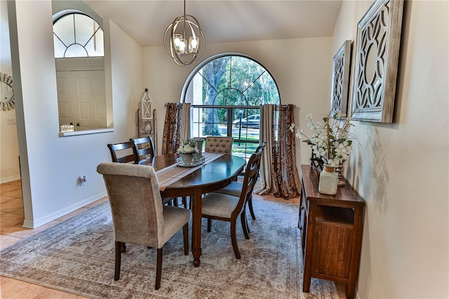 tiled dining area featuring an inviting chandelier