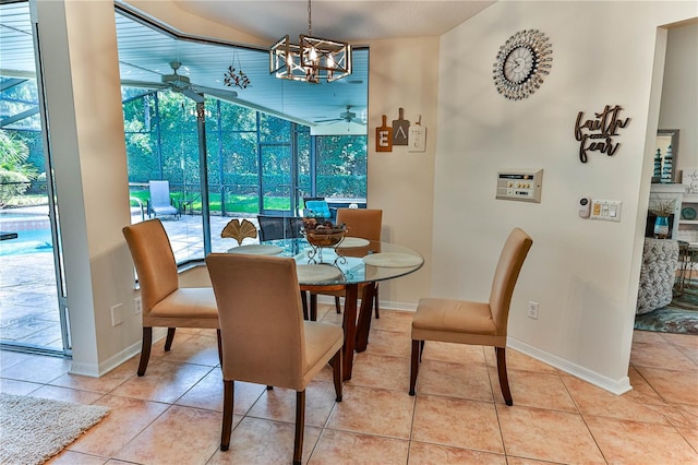 tiled dining space with ceiling fan with notable chandelier