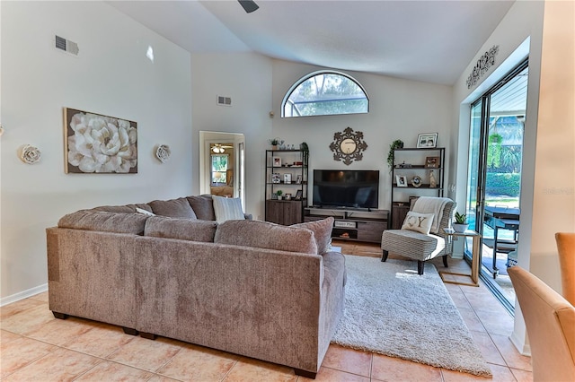 tiled living room with high vaulted ceiling