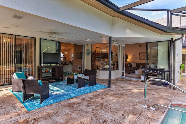 view of patio featuring a lanai and ceiling fan