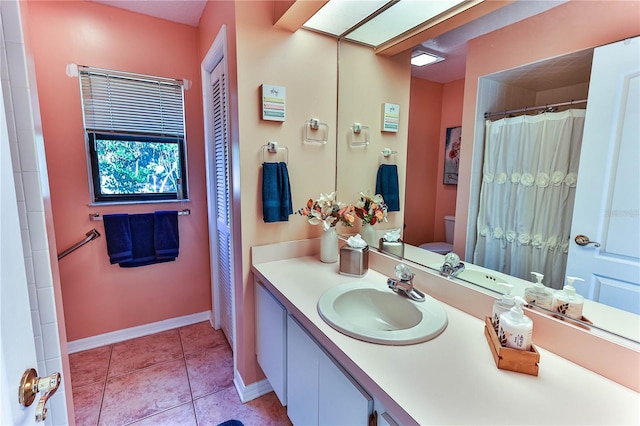 bathroom featuring vanity, toilet, and tile patterned flooring