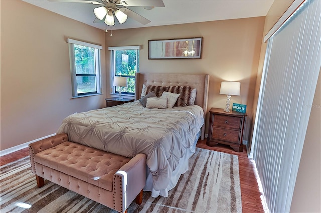 bedroom with hardwood / wood-style flooring, ceiling fan, and a closet