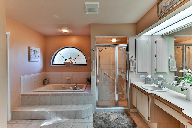 bathroom with vanity, plus walk in shower, and tile patterned flooring