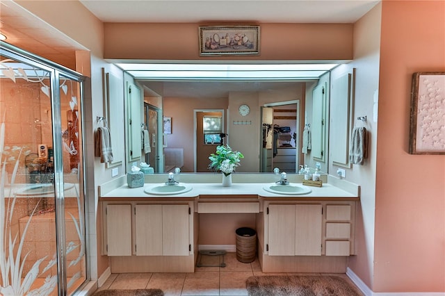 bathroom with vanity, tile patterned flooring, and a shower with door