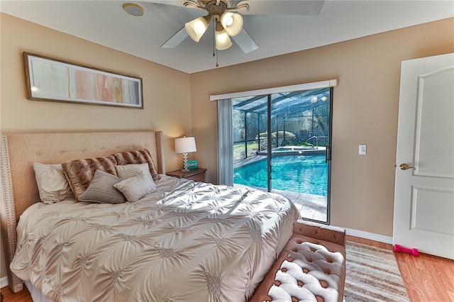 bedroom featuring ceiling fan, wood-type flooring, access to exterior, and multiple windows