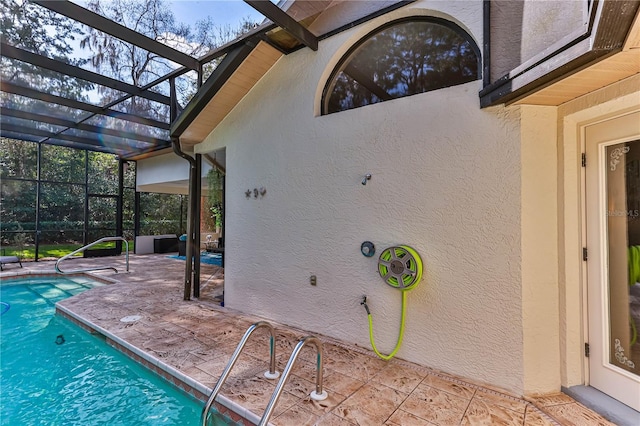 view of swimming pool with a lanai and a patio