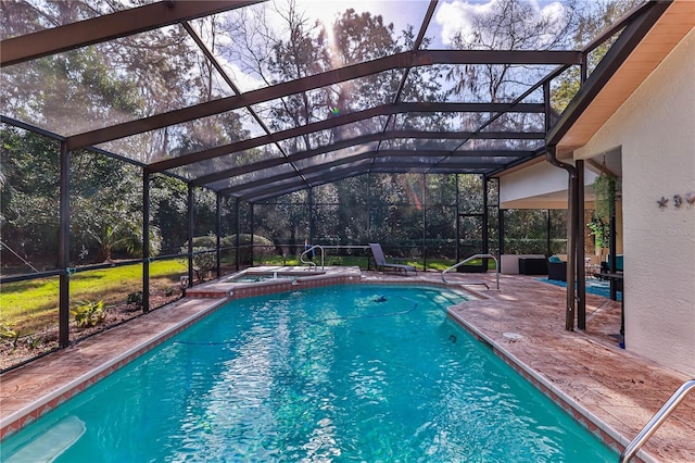 view of swimming pool with an in ground hot tub, glass enclosure, and a patio