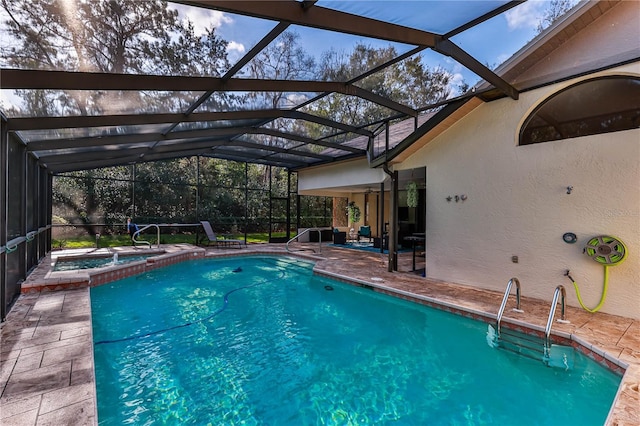 view of pool with a lanai, a patio area, and an in ground hot tub