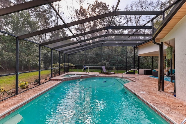 view of pool featuring an in ground hot tub, a lanai, and a patio area